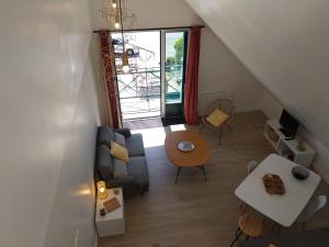 a living room with a couch and a table at Alizée in Granville