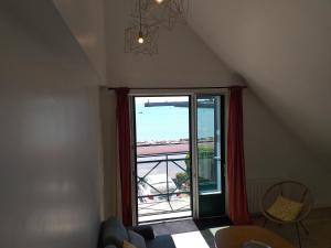 a room with a large window with a view of the ocean at Alizée in Granville