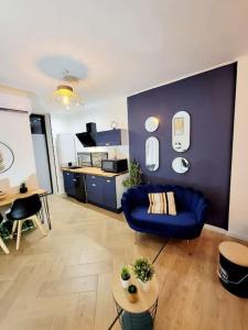 ein Wohnzimmer mit einem blauen Sofa und einem Tisch in der Unterkunft le Very Cozy in Albi
