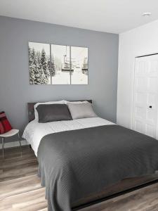 a bedroom with a bed and a ski lift at ST-DO du LAC in Saint-Donat-de-Montcalm