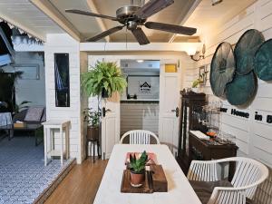 a dining room with a ceiling fan and a table at W home The Thai-style tranquil and cozy villa in Bangkok