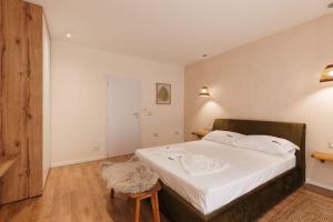 a bedroom with a large bed with white sheets at Garden by Holistay in Tirana