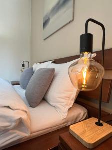 a lamp on a table next to a bed at Arboro Borovets Gardens E43 in Borovets