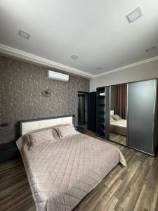 sypialnia z dużym łóżkiem i lustrem w obiekcie Villa in Dzoraghbyur w Erywaniu