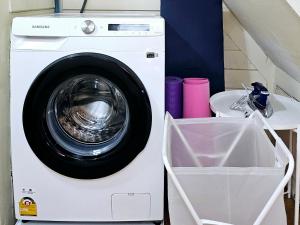 a white washing machine sitting next to a sink at W home The Thai-style tranquil and cozy villa in Bangkok