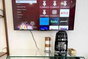 a glass table with a coffee maker and a tv at The Phenix Historic DTWN Hotel, King Bed, Room # 309 in Bangor +8 photos