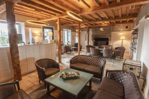 a lobby with a table and chairs and a bar at Logis Hôtel la Grassinais Saint-Malo in Saint Malo