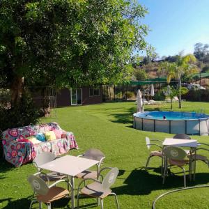 a yard with tables and chairs and a pool at The Place in Albufeira