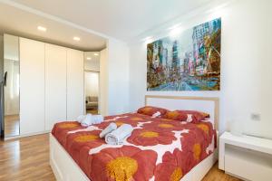 a bedroom with a bed with a painting on the wall at Luxury Loft en Maspalomas con Terraza y Piscina in Maspalomas +26 photos