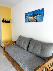 a couch in a room with a picture on the wall at Moderno y Luminoso Departamento in Buenos Aires