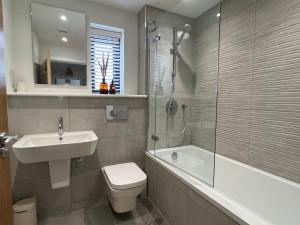 a bathroom with a sink and a toilet and a shower at Exceptional 3 bedroom home in Penzance~New~Seaside in Penzance
