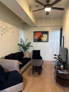 a living room with a couch and a tv at 2BR Top Floor spacious unit in Mandaluyong in Manila