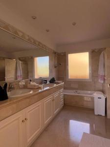 a bathroom with a tub and a sink and a bath tub at R26 Stunning Penthouse Duplex Elviria in Marbella