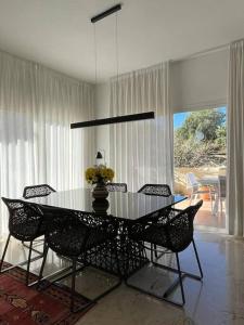a dining room with a glass table and chairs at R26 Stunning Penthouse Duplex Elviria in Marbella