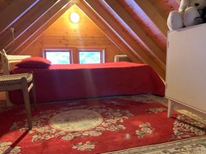 a bedroom with a red bed in a attic at Beautiful Cottage in Hveragerdi in Hveragerði