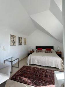 a white bedroom with a bed and a rug at R26 Stunning Penthouse Duplex Elviria in Marbella