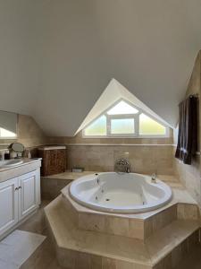 a large bathroom with a large tub and a window at R26 Stunning Penthouse Duplex Elviria in Marbella
