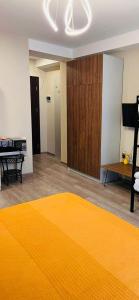 a living room with a yellow rug on the floor at Crystal Wood Apartment 213 in Bakuriani
