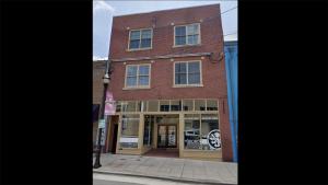 a brick building on the corner of a street at Broken Clock in Springfield