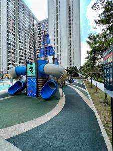 a playground in the middle of a street with tall buildings at The Deluxe at Horizon Suites KLIA in Kampong Melot