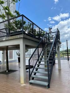 a stairway with a railing on top of a building at The Deluxe at Horizon Suites KLIA in Kampong Melot +22 photos