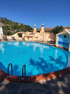 a large swimming pool in a resort at Villa Su Navru in Irgoli
