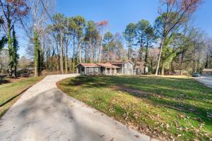 a driveway leading to a house in the woods at Smart Home in Heart of Snellville in Snellville
