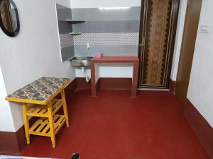 a small bathroom with a table and a sink at RAJ MAHAL GUEST HOUSE in Shānti Niketan