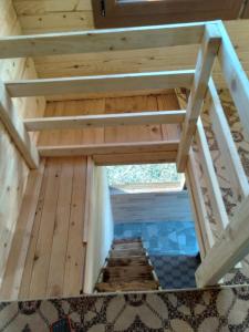 a view of the inside of a wooden house with stairs at Birlik Yaylakent in Sultan Murat Yaylasi