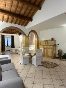 a living room with a couch and a table and chairs at Villa Oasi in Ferrara