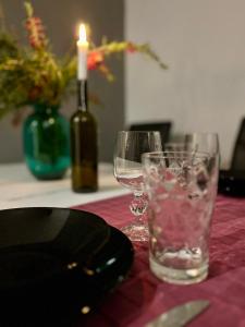 a table with two glasses and a bottle of wine at Thalia Apartments in Agia Galini