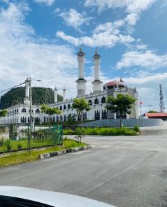 un edificio blanco con dos torres encima en LH Homestay Suite Gua Musang- Masjid Mekah, en Gua Musang
