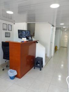 un ufficio con scrivania e uno sgabello in una stanza di Eugenia Hotel Valledupar a Valledupar