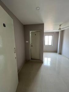 an empty room with a door and a hallway at vaishnav cottage in Agartala