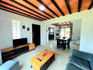 a living room with a couch and a table at Casa piscina Atlantida in Atlántida