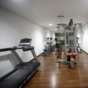 a gym with several treadmills and cardio machines at Hotel Carris Marineda in A Coruña