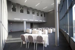 a banquet hall with white tables and chairs at Hotel Carris Marineda in A Coruña +50 photos