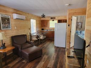 a living room with a refrigerator and a chair at Southern Comfort Inn & Resort in Fairfield Bay
