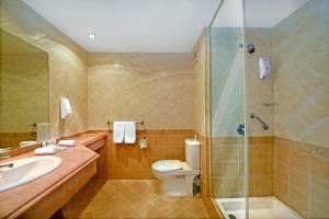 a bathroom with a toilet and a sink and a shower at Bliss Nada Beach Resort in Marsa Alam City