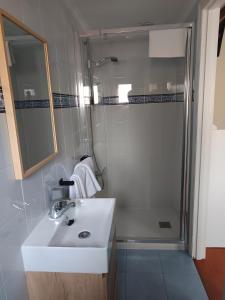 a bathroom with a sink and a shower at Pensión liebana in San Vicente de la Barquera