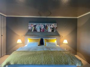 a bedroom with a bed with a picture on the wall at bed,Beet&breakfast „ds aute Pfarrhuus“ in Rapperswil