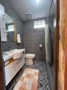 a bathroom with a sink and a toilet at Theresa's Pension House in San Vicente