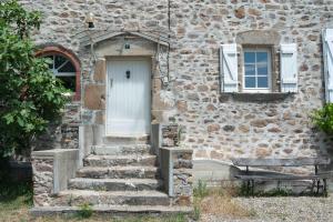 a stone house with stairs leading to a door at La Terrade 