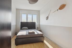 a bedroom with a bed and a window at Le Calme à deux pas de Paris in Nanterre