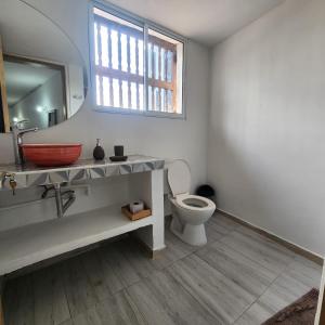 a bathroom with a sink and a toilet and a mirror at Casa Matuna - Cartagena in Cartagena de Indias