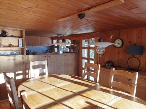 a kitchen with a wooden table and chairs at Chalet Beau Site in Le Sépey