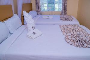 Un ou plusieurs lits dans un hébergement de l'établissement Calfie Resort Kisumu