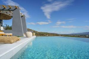 a swimming pool with a view of the water at Villa Capparis in Moírai