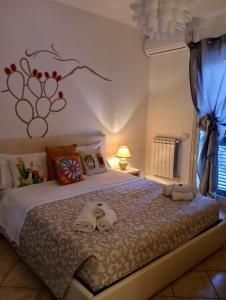 a bedroom with a bed with towels on it at B&B fragranza di sicilia in Giardini Naxos
