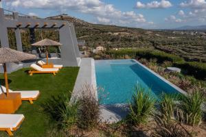 a villa with a swimming pool and a view at Villa Capparis in Moírai